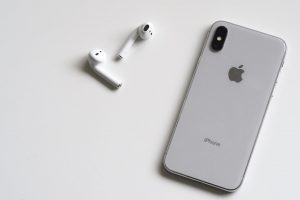 silver iphone x with airpods