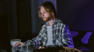 a man sitting at a table using a computer