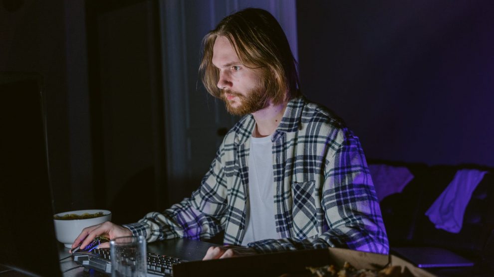 a man sitting at a table using a computer