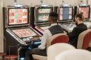 men sitting in front of a slot machine