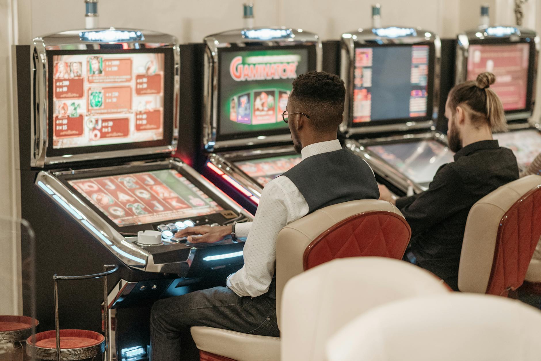 men sitting in front of a slot machine